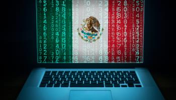 A laptop with the Mexican flag and codes on its screen (Shutterstock)