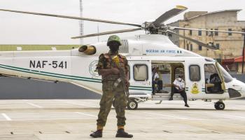 Nigerian soldier guarding President Muhammadu Buhari's helicopter, June 2021 (Olukayode Jaiyeola/NurPhoto/Shutterstock)