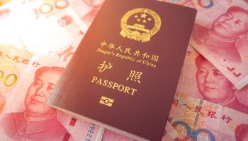 Chinese passport and renminbi notes (Shutterstock)