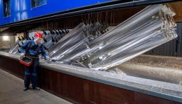 German manufacturing worker moving metal pieces (Michael Probst/AP/Shutterstock)