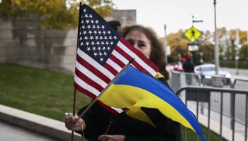 A woman holds US and Ukrainian flags before attending a pro-Ukraine demonstration in Chicago, October 16, 2022 (Beata Zawrzel/NurPhoto/Shutterstock)