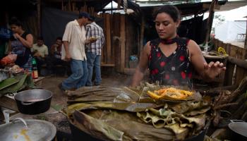 A Nicaraguan refugee serves up food at a camp in Upala, northern Costa Rica. February 2020 (Moises Castillo/AP/Shutterstock)
