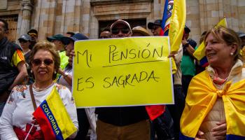 A protester holds a banner that reads 'My pension is sacred' during demonstrations against government reform proposals. Bogota, February, 2023. (Chepa Beltran/Vwpics/VW Pics via ZUMA Press Wire/Shutterstock)