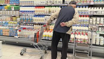 Elderly man in supermarket looks at dairy shelves, Moscow, May 15, 2022 (Oxana A/Shutterstock). 