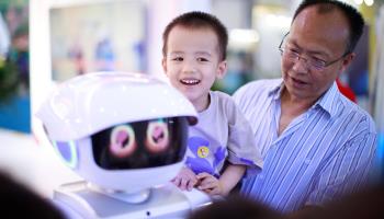 A child interacts with a robot at the China International Big Data Industry Expo 2023 in Guiyang (CHINE NOUVELLE/SIPA/Shutterstock)