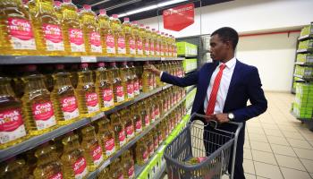 A customer shopping for cooking oil in a supermarket in Harare (Aaron Ufumeli/EPA-EFE/Shutterstock)