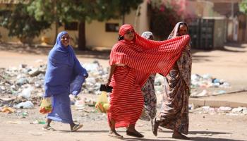 Sudanese women fetch supplies in Khartoum after the outbreak (STRINGER/EPA-EFE/Shutterstock)