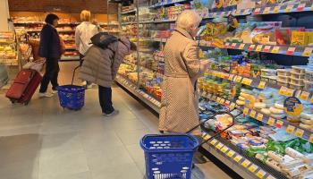 An elderly woman stands at the cheese section in a supermarket, Moscow, April 29, 2022 (Oxana A/Shutterstock)