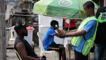 Electoral officer conducts voter verification scan for Nigerian state-level elections, March 18 2023 (Akintunde Akinleye/EPA-EFE/Shutterstock)