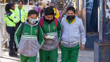 Three boys walk to school in Puebla, Mexico. February 2023. (Shutterstock)