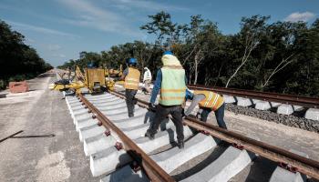 Workers install rails for the Maya Train near Cancun, Quintana Roo (Shutterstock)