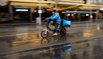 A food delivery worker on Swanston Street in Melbourne, August 14, 2020 (Speed Media/Shutterstock)
