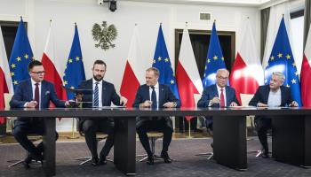 Szymon Holownia (L), head of the Poland 2050 party, and Wladyslaw Kosiniak-Kamysz, head of the Polish People's Party, which have formed the Third Way; Donald Tusk (C), head of the Civic Coalition; and Wlodzimierz Czarzasty and Robert Biedron (R), the co-chairmen of The Left, sign a governing coalition agreement, Warsaw, November 10 (Attila Husejnow/SOPA Images/Shutterstock)