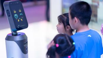 Children interact with a robot at the Smart China Expo (Shutterstock)
