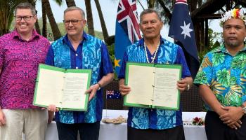 Australian Prime Minister Anthony Albanese and Tuvalu Prime Minister Kausea Natano display the bilateral agreement signed in the Cook Islands on November 9, 2023 (Ben McKay/EPA-EFE/Shutterstock)