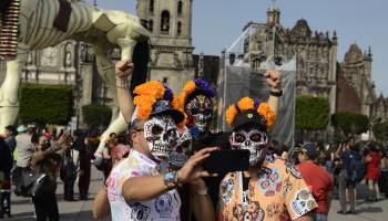 Tourists with skull masks take a selfie on the Day of the Dead in Mexico City, November 1, 2023 (Carlos Tischler/Eyepix Group/Shutterstock)