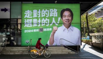 A cyclist passes a campaign ad for Democratic Progressive Party candidate Lai Ching-te ahead of January’s elections (Wiktor Dabkowski/ZUMA Press Wire/Shutterstock) 