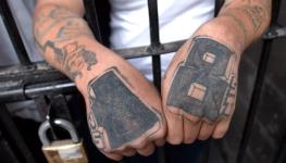 The tattooed hands of a prisoner at the Tamara National Penitentiary, near Tegucigalpa (David De La Paz/EPA/Shutterstock)
