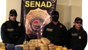 Paraguayan anti-drugs officers with a seized cocaine consignment (Andres Cristaldo/EPA/Shutterstock)