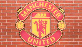 The Manchester United crest on a wall at the club’s Old Trafford stadium (Simon Belcher/imageBROKER/Shutterstock)
