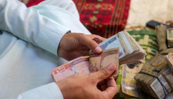 An Afghan currency dealer at work (Samiullah Popal/EPA-EFE/Shutterstock)
