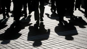 The Shadows of Japanese Office Workers Are Cast On the Pavement in Downtown Tokyo (Dai Kurokawa/EPA/Shutterstock)