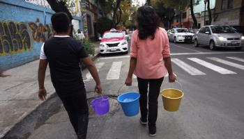 Mexico City residents carry buckets of water supplied by tanker (Sashenka Gutierrez/EPA-EFE/Shutterstock)