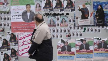 A man looking at election posters in Tehran, February 26 (Morteza Nikoubazl/NurPhoto/Shutterstock)