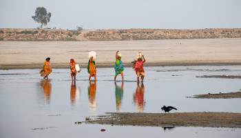 People cross a dry riverbed in Bogura, Bangladesh (Joy Saha/ZUMA Press Wire/Shutterstock)