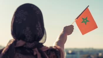 Woman holding the Moroccan flag (Shutterstock)