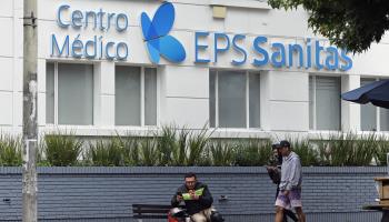 People walk past an EPS Sanitas medical centre in Bogota. April 2024 (Mauricio Duenas Castaneda/EPA-EFE/Shutterstock)