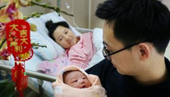 A couple and their newborn baby at a hospital in Heshan, Guangdong province (Xinhua/Shutterstock)