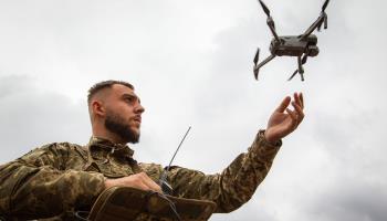 A Ukrainian soldier launching a drone (Ukrinform/Shutterstock)