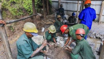 Workers sorting out extracted tungsten minerals in Rwanda (Xinhua/Shutterstock)