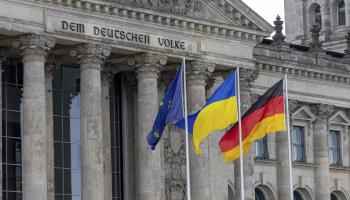 EU, German and Ukraine flags outside Germany’s federal parliament (Christian Ender/imageBROKER/Shutterstock)