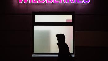 A man walks past one of the Wildberries delivery points in the evening in St. Petersburg (Artem Priakhin/SOPA Images/Shutterstock)