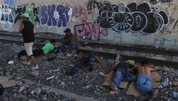 Migrants rest by a railway line in northern Mexico, July 2023 (Luis Torres/EPA-EFE/Shutterstock)