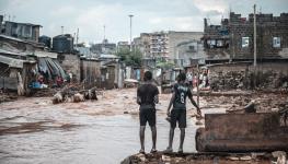 Children watch as flood waters run through Nairobi's Mathare slum, Kenya, April 30, 2024 (Xinhua/Shutterstock)