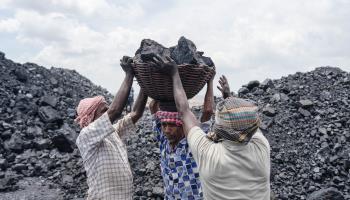 Workers carrying coal near an opencast coal mine in Jharkhand state (Amarjeet Kumar Singh/SOPA Images/Shutterstock)