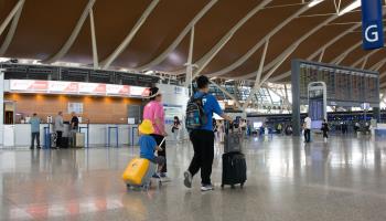 Travellers at Shanghai’s Pudong International Airport (Ying Tang/NurPhoto/Shutterstock)

