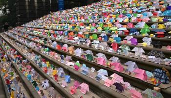 Origami houses placed on the steps of Victoria’s state parliament to symbolise the need for housing, July 31, 2024 (James Ross/EPA-EFE/Shutterstock)