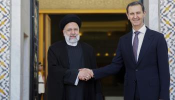 President Bashar al-Assad (right) with former Iranian President Ebrahim Raisi (left) (ATPImages/GettyImages)

