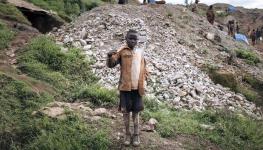 A child poses for a photograph at an artisanal gold mining site in South Kivu, May 11, 2023 (Alexis Huguet/AFP/Getty Images)

