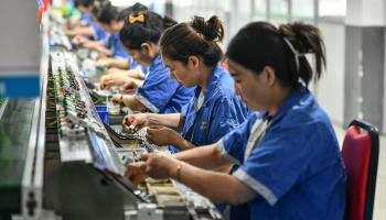 Employees work on a circuit breaker production line at a factory of an electronics company in Fuyang (STR/AFP/Getty Images)