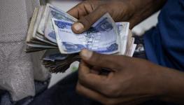 A shop owner counts birr in Addis Ababa, December 4, 2023 (Michele Spatari/AFP/Getty Images) 