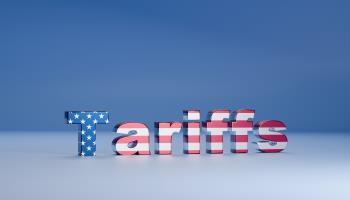 US flag over a tariffs sign (Wong Yu Liang/Moment RF/Getty Images)