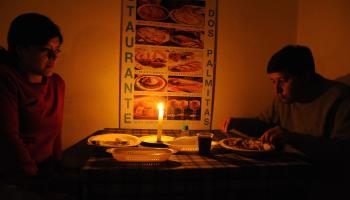 Customers at a Quito restaurant eat by candlelight during a blackout (Rodrigo Buendia/AFP/Getty Images)