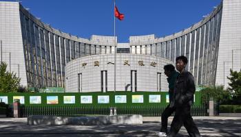 People walk past the People’s Bank of China in Beijing (Adek Berry/AFP/Getty Images)

