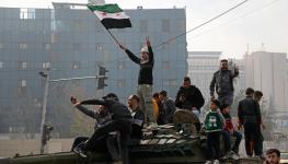 Syrians celebrating the fall of President Bashar al-Assad (Ali Haj Suleiman/Getty Images)