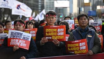 Striking railway workers hold signs during a protest over wages and recruitment in Seoul (Philip Fong/AFP/Getty Images) 